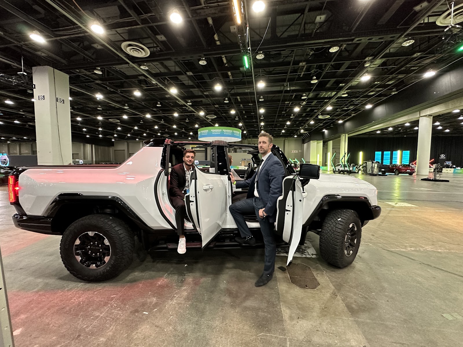 Carviz CEO Côme Pinczon du Sel (left) and COO Rob Kazmarek test drive GMC’s new Hummer EV Pickup Truck at the 2023 Detroit Auto Show