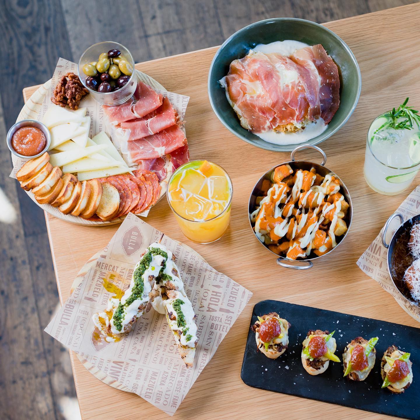 Top down view of appetizers and drinks at Bulla Gastrobar