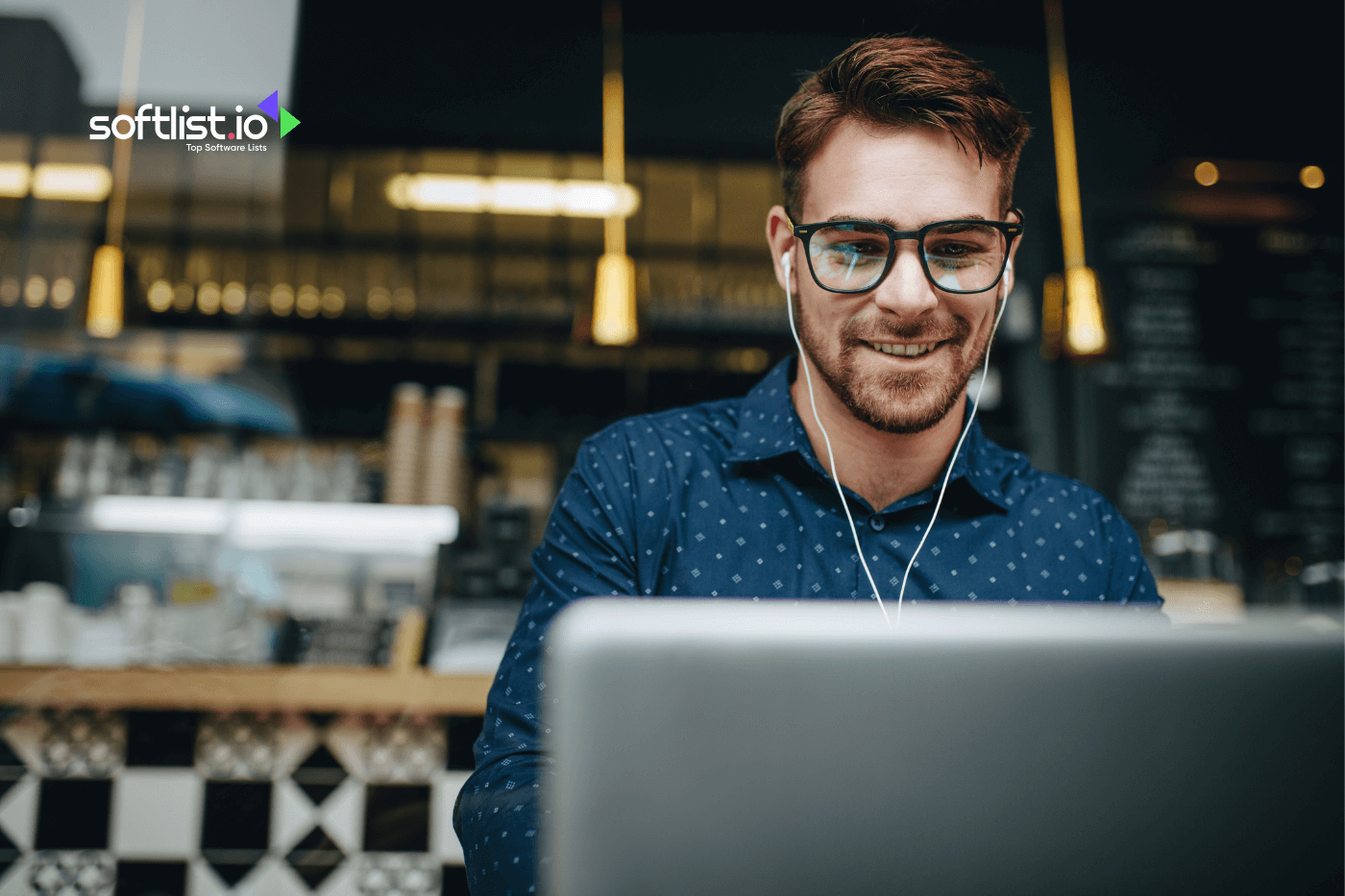 a man using his laptop and earphones on