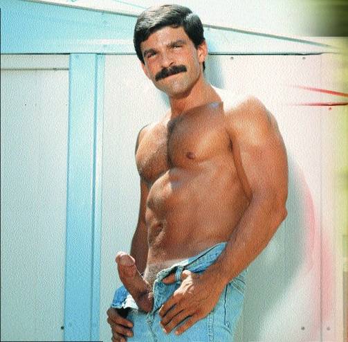 Rod Mitchell posing shirtless wearing light denim showing off his erect dick peeking out of his pants