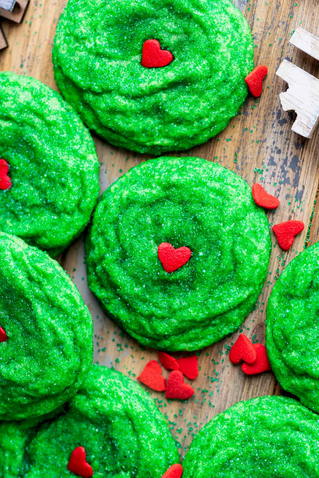 green sugar cookies with tiny red hearts
