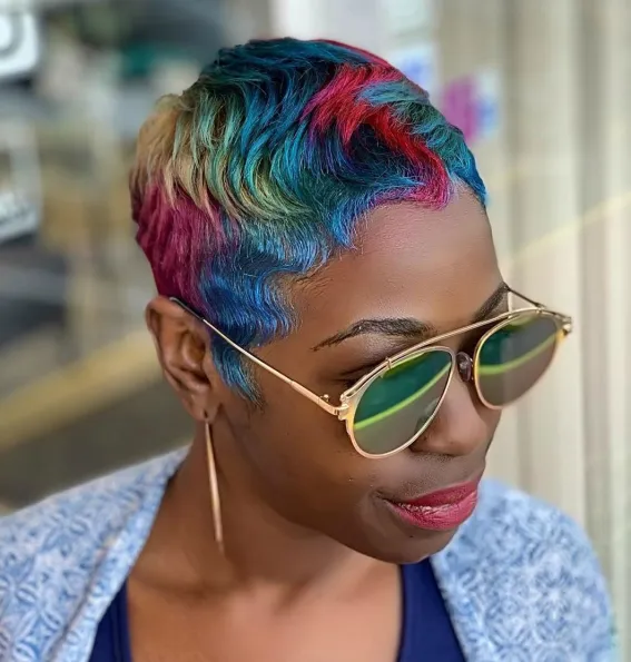 Picture of a lady wearing  the rainbow hair color pixie cut