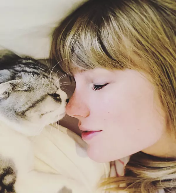 Picture of Taylor snuggling her pet