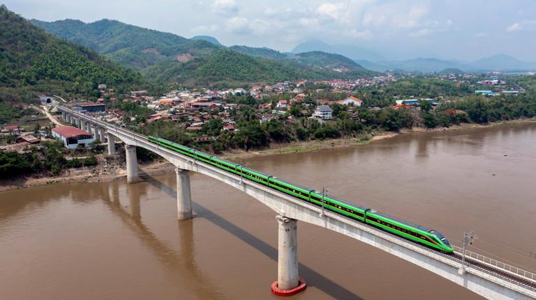 A train crosses a bridge across the Mekong River near Luang Prabang on the Boten-Vientiane railway in Laos, built as part of the Belt and Road Initiative. Photo: Xinhua