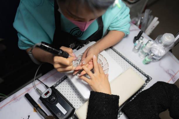 Manicurist doing manicure to lady Manicurist doing manicure to lady Gel Nail  stock pictures, royalty-free photos & images
