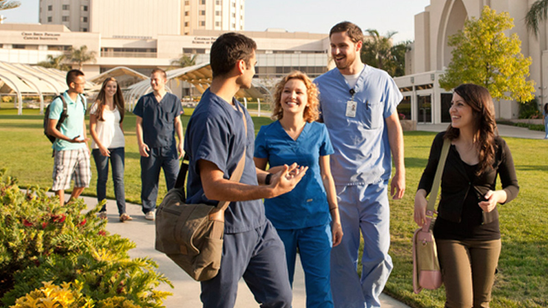 A photo of a group of medical students at Loma Linda University School of Medicine walking the pathway.
