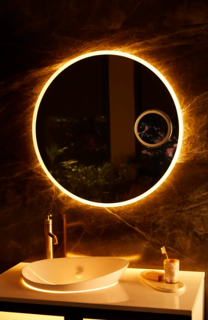 A round mirror with a light on the wall

Description automatically generated