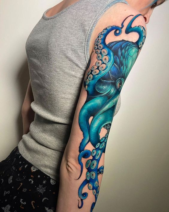 Lady shows off the colorful tat design on her arm