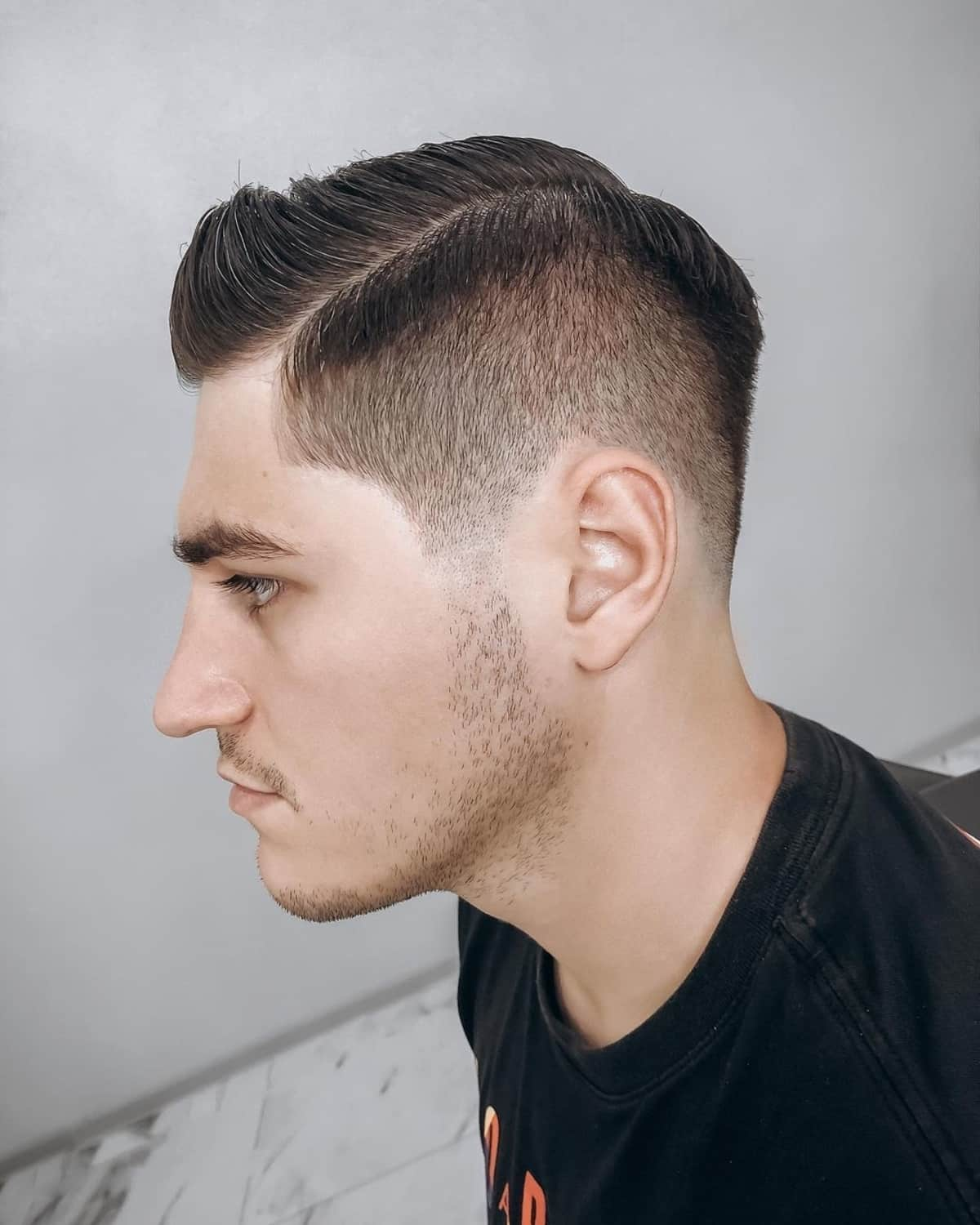Side view of a guy rocking the regulation cut