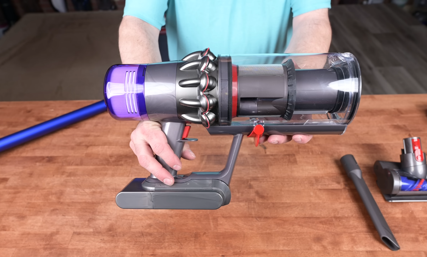 A person holding the Dyson V11 cordless vacuum
