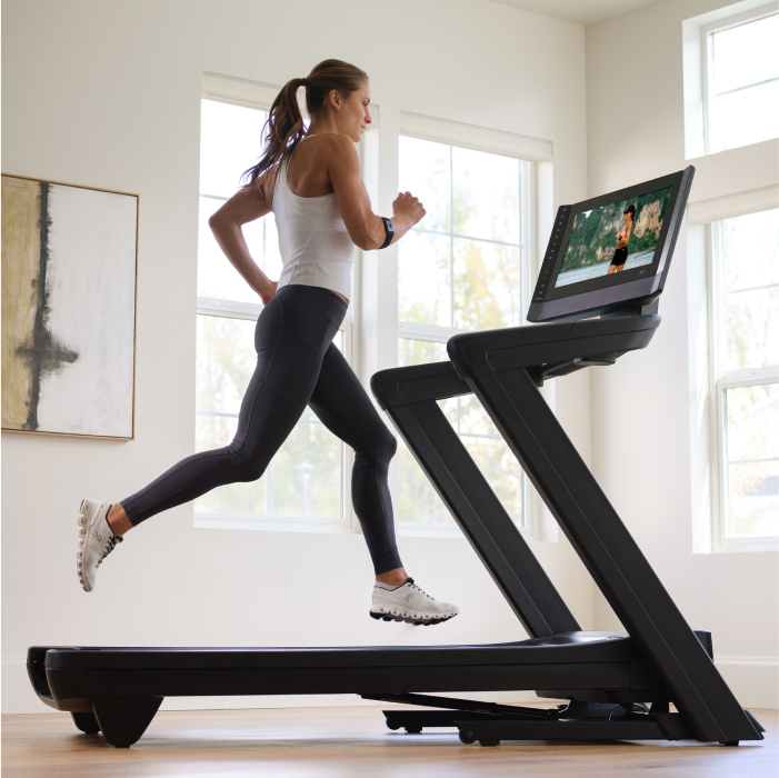 Woman Running on Her NordicTrack Treadmill Using an iFIT Workout With Trainer Stacey Clark