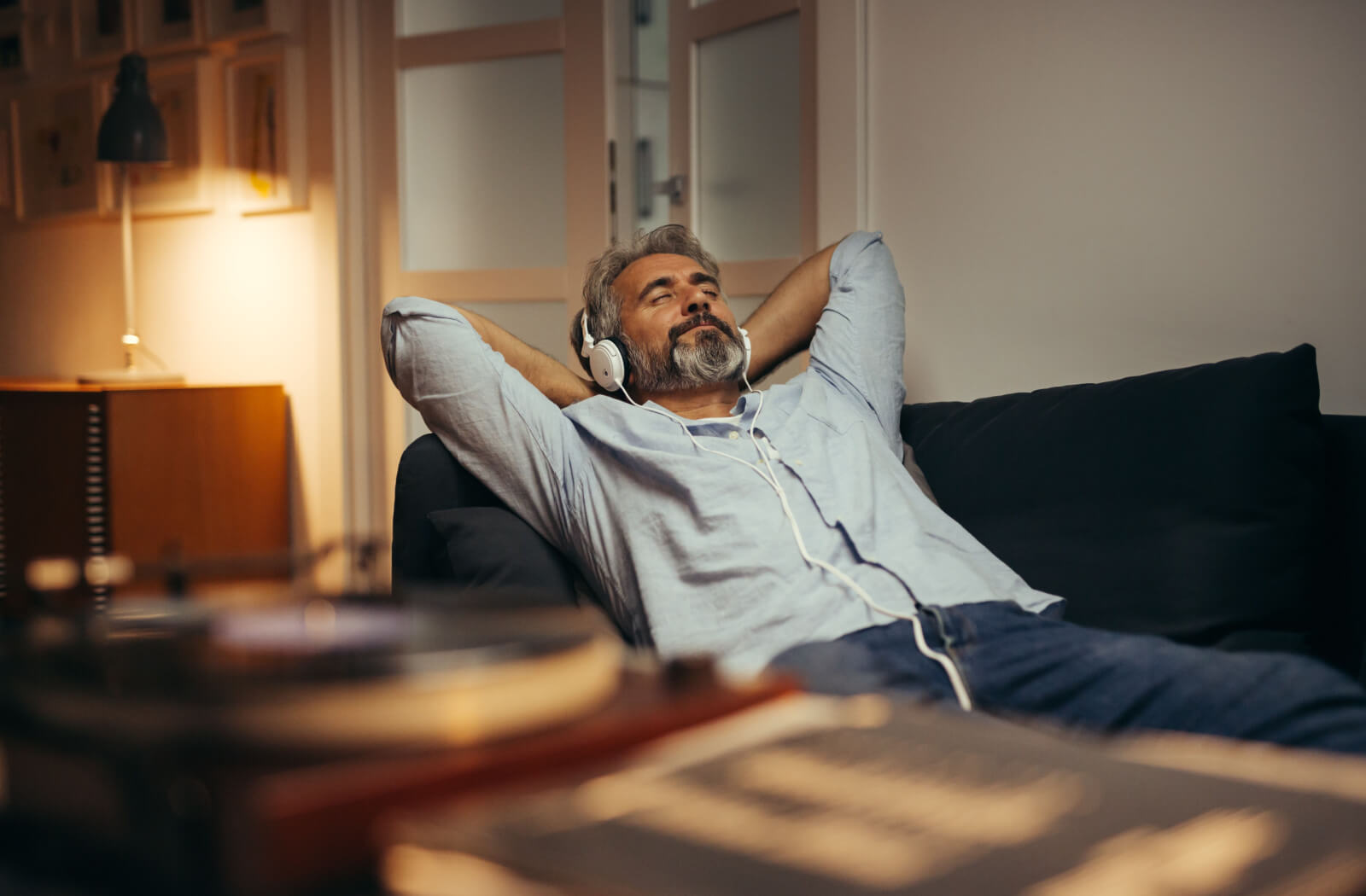 A senior man relaxing and listening to music.
