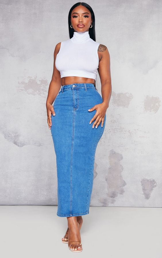 Picture of  a lady rocking a crop top with a jean skirt