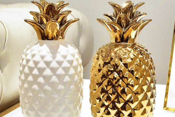 White ceramic pineapple with a glossy finish.