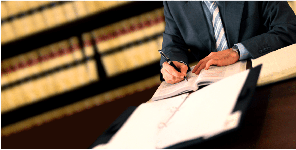 The Fran Haasch Law Group lawyer writing on legal documents 