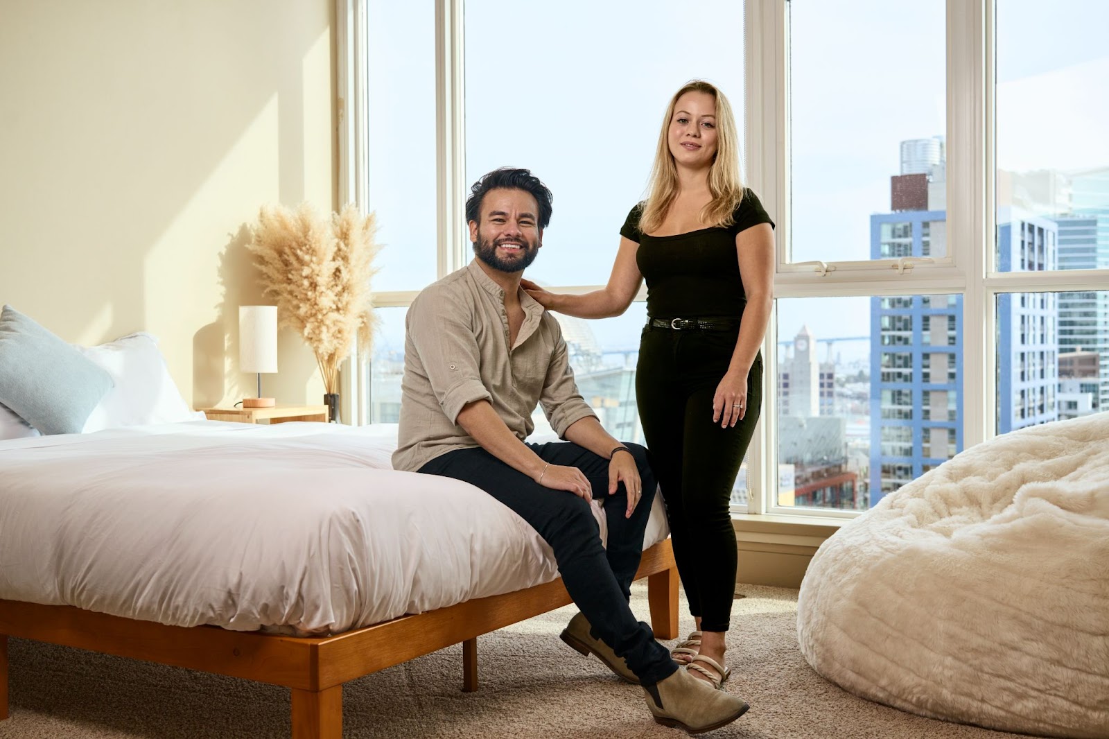 Couple in a brightly lit bedroom. 