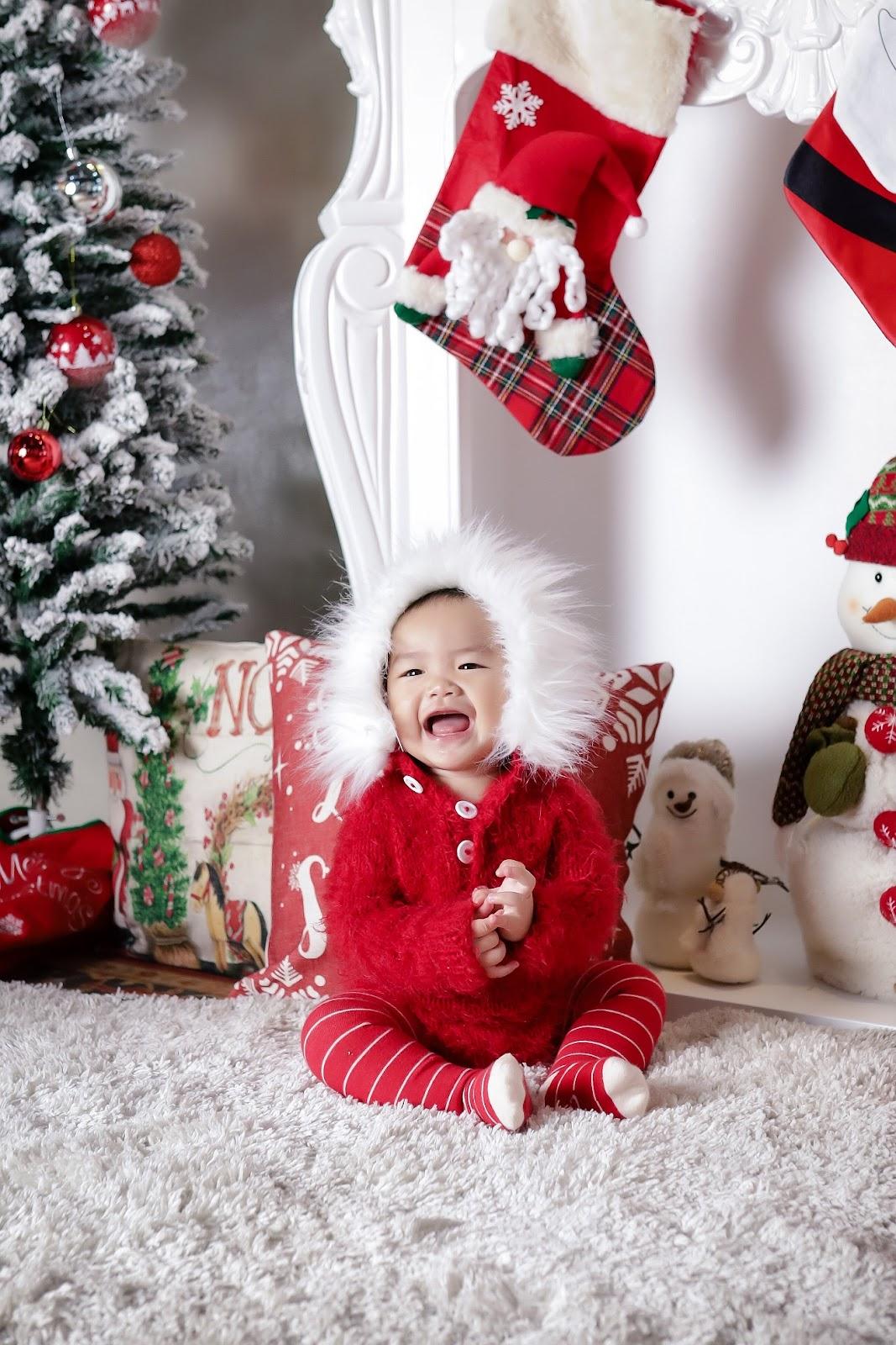 newborn christmas photo idea: baby wearing an Eskimo outfit posing in a winter-inspired setup