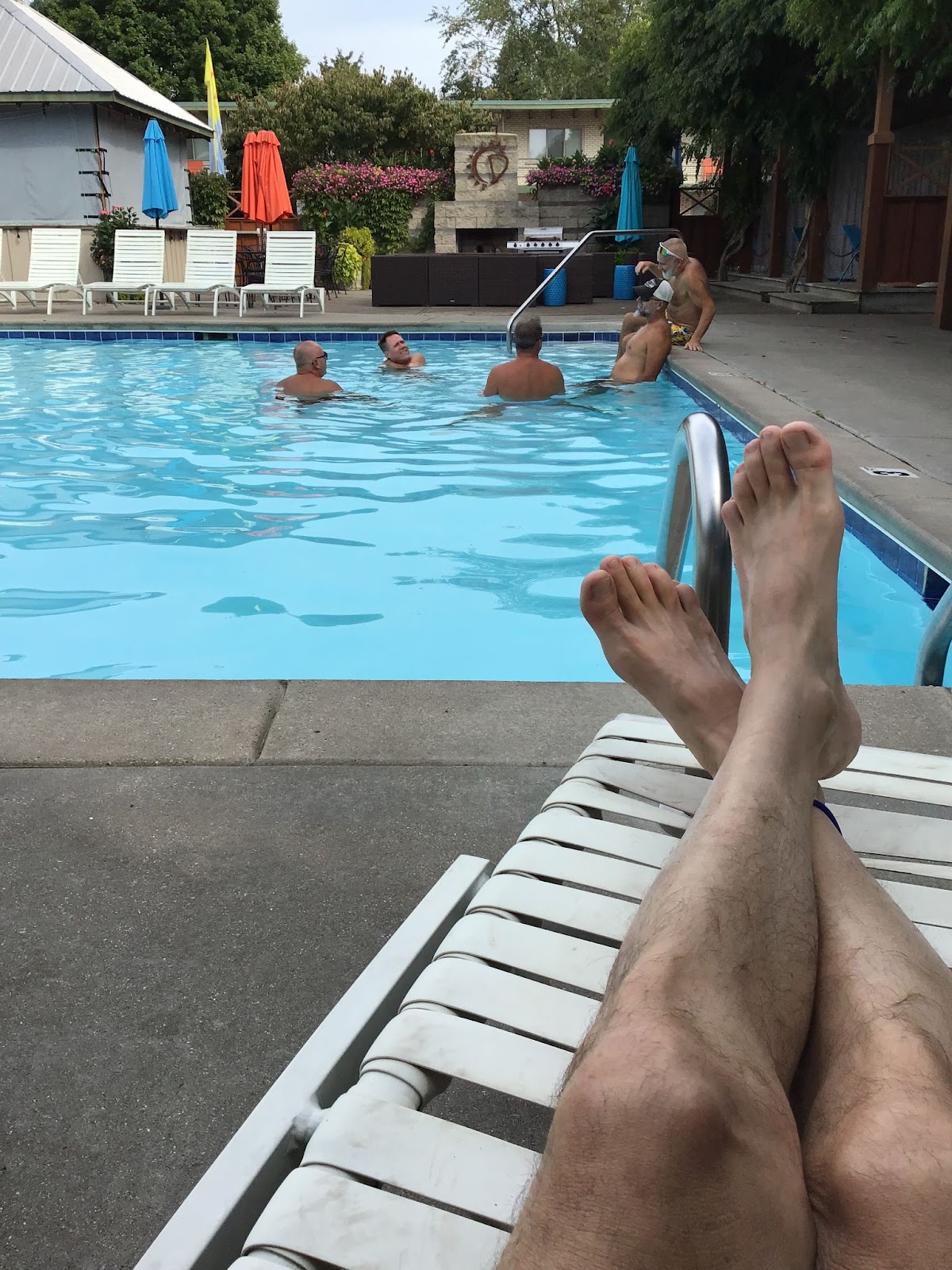male feet relaxing by the pool at the dunes pool gay resort in michigan USA
