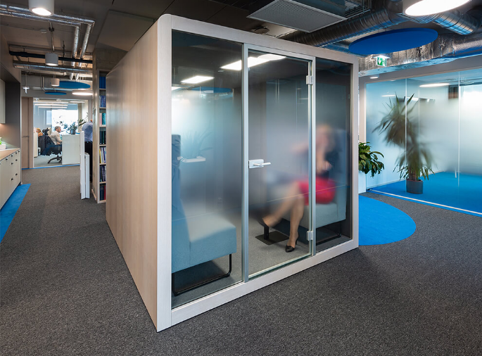 Office phone booth with blue sofa