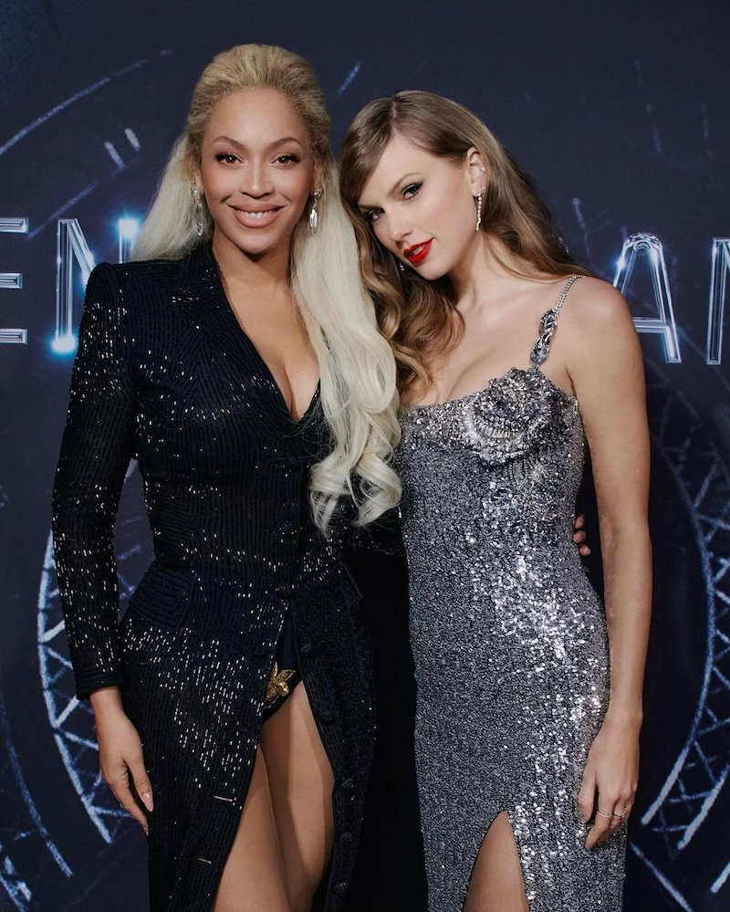  Beyonce is standing next to Taylor Swift. Taylor has blonde hair. Beyonce has blonder hair.