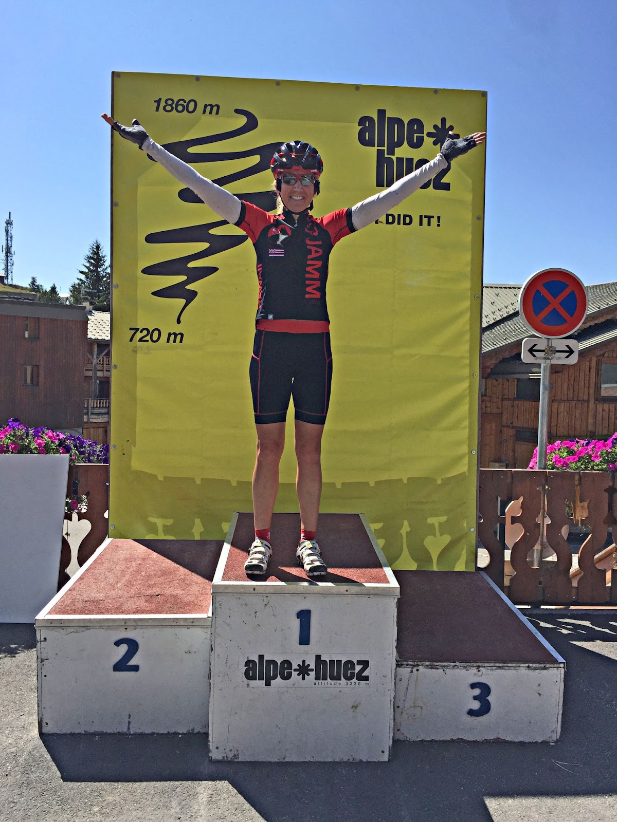 PJAMM Cyclist stands on Tour de France podium on Alpe d'Huez bike climb