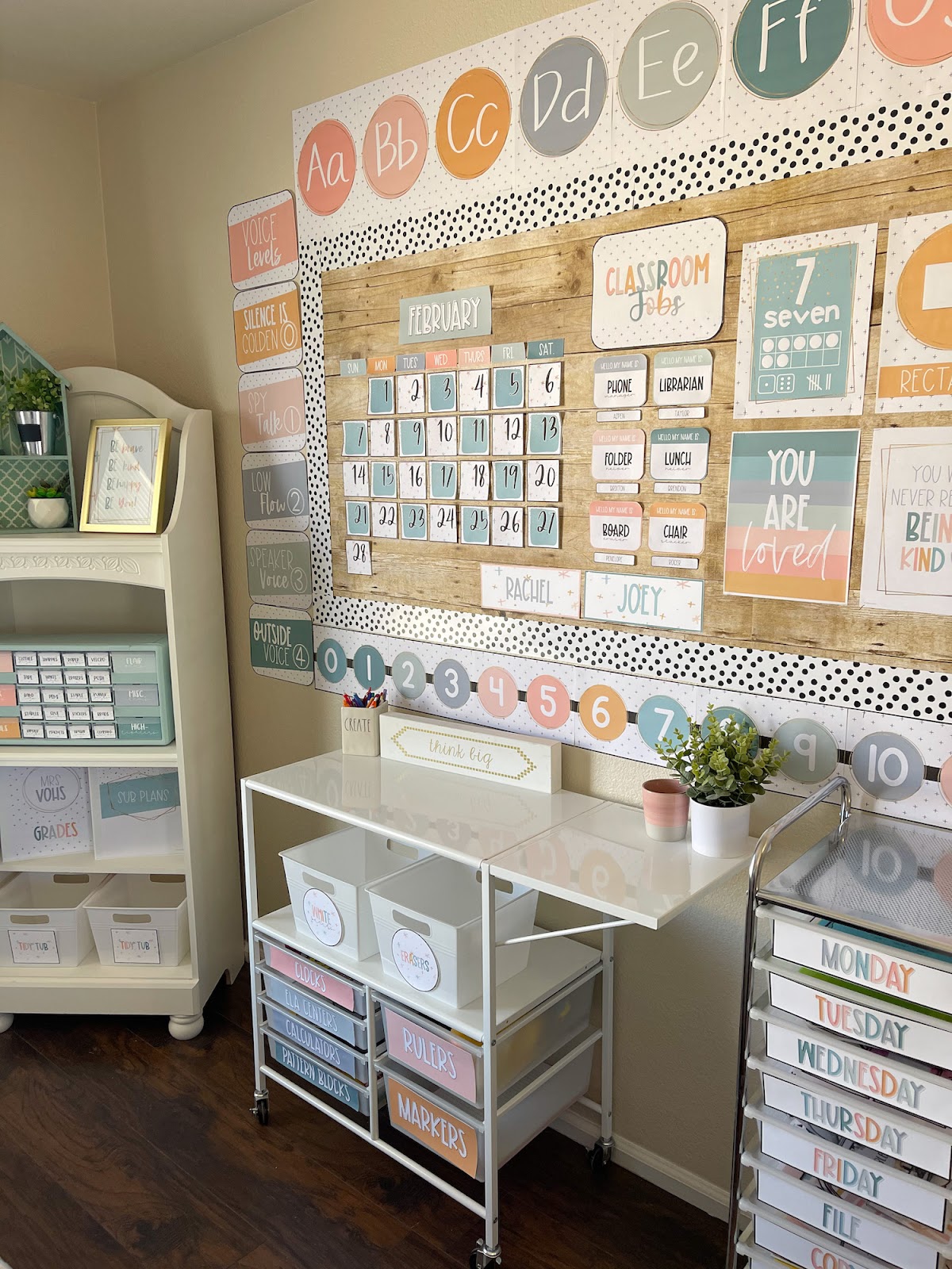This image shows a sample classroom decorated with the modern calm colors decor bundle. You can see a bulletin board, 10-drawer cart with labels, alphabet posters, and more! 