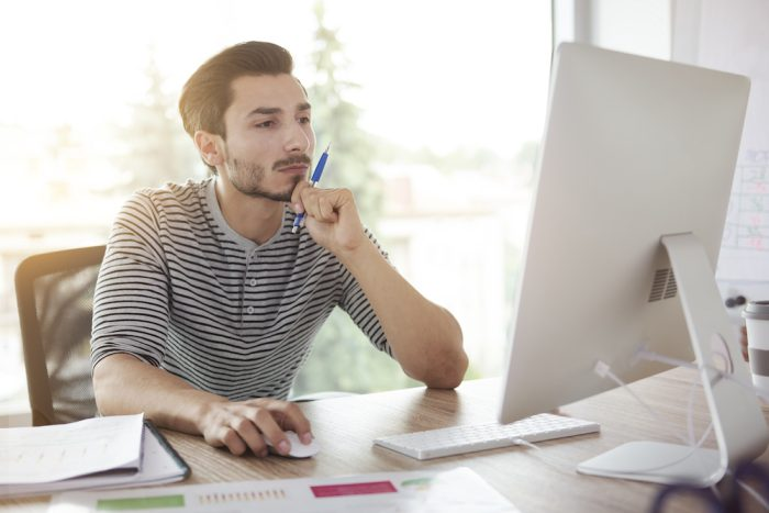 photo of man using computer