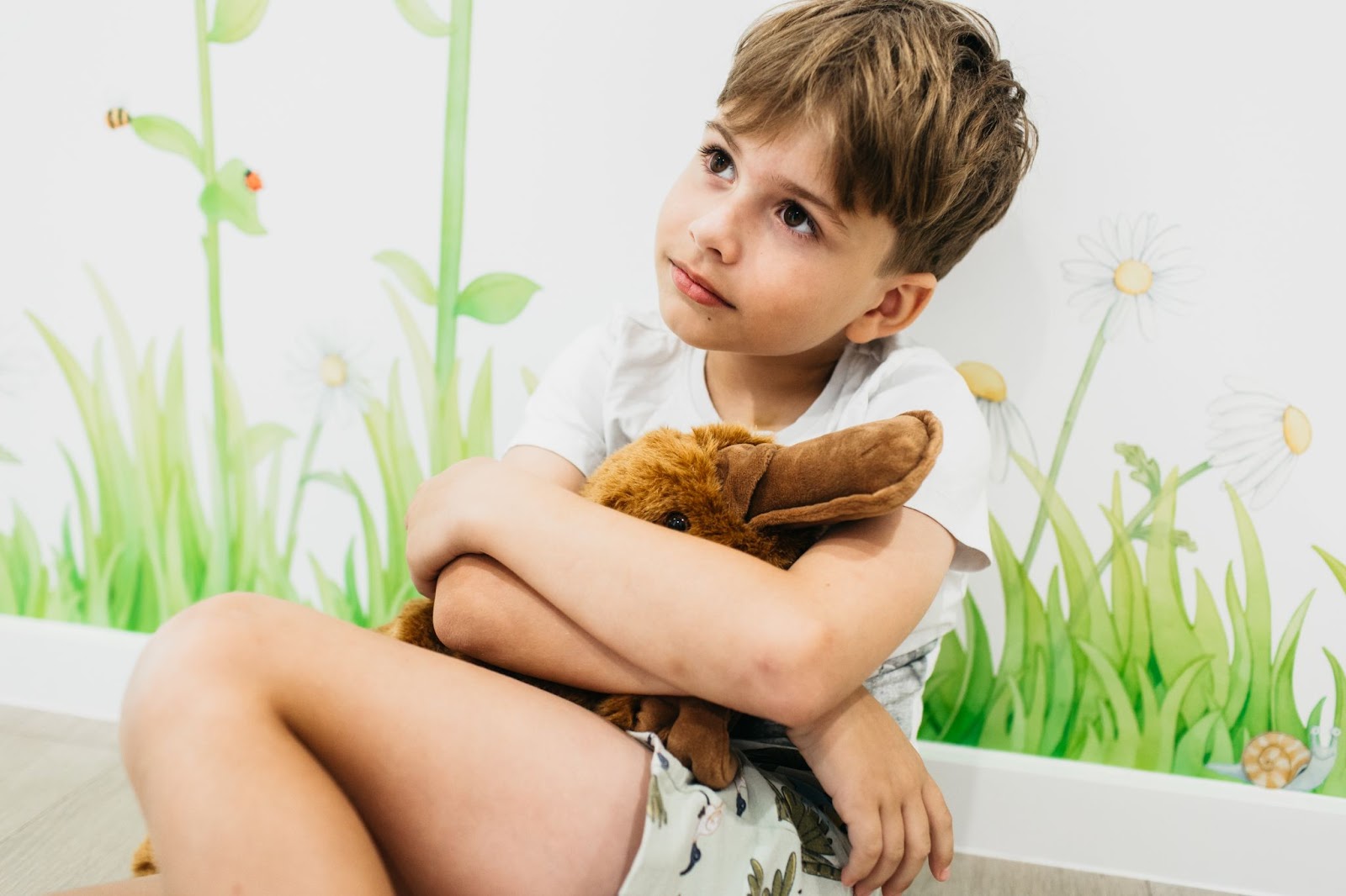 child is sitting with a weighted toy