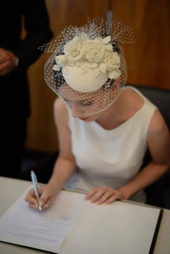 Picture of a lady  rocking her gorgeous head piece with her wedding gown
