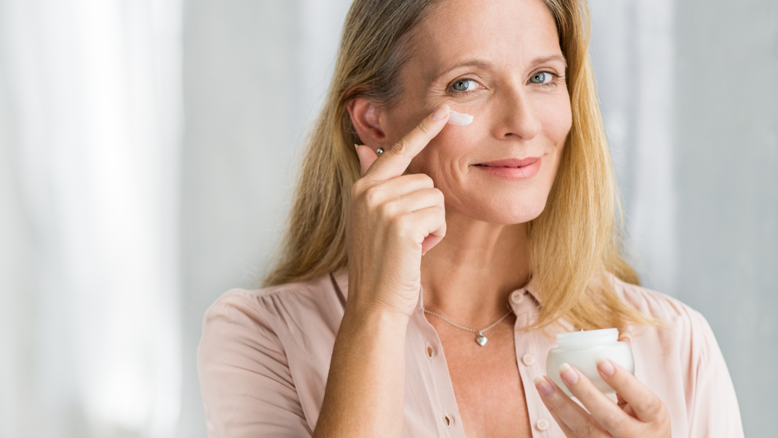 woman applies cream to face for article about the best natural facial moisturizers for dry skin