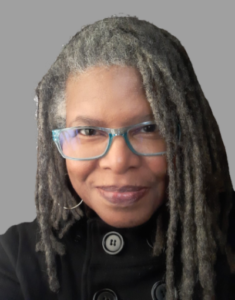 A person with glasses and dreadlocks

Description automatically generated