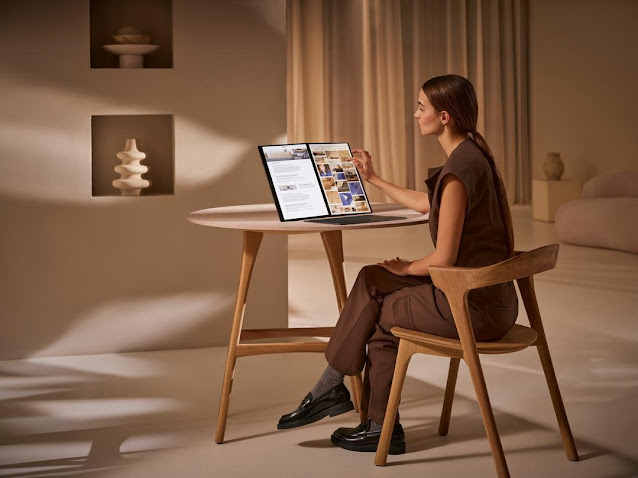 A person sitting at a table using a computerDescription automatically generated