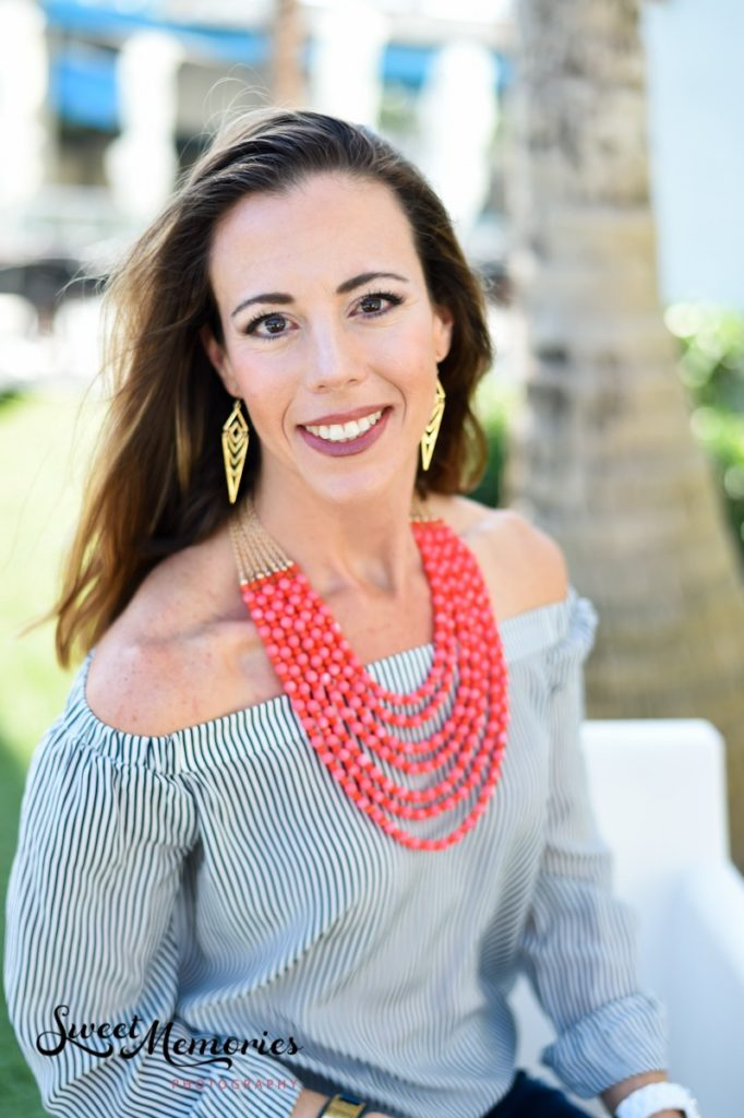 A woman in an outdoor setting posing for an acting headshot