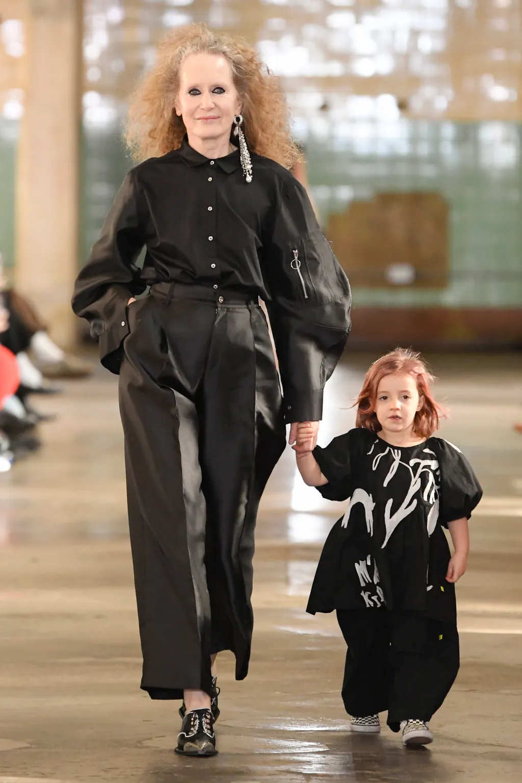 Picture showing a Grand mother and her daughter strutting the fashion show