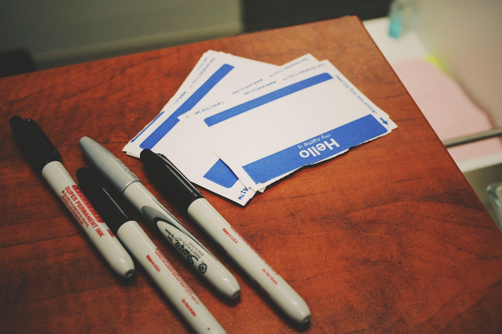 Name tags with sharpies on a desk