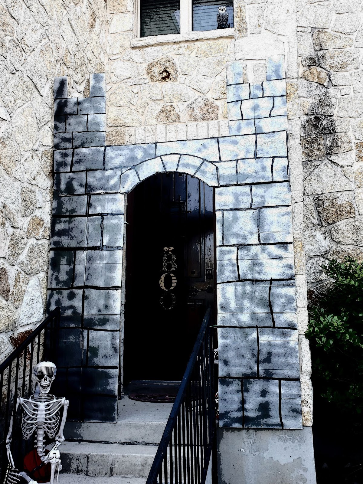 a stone building with a black door