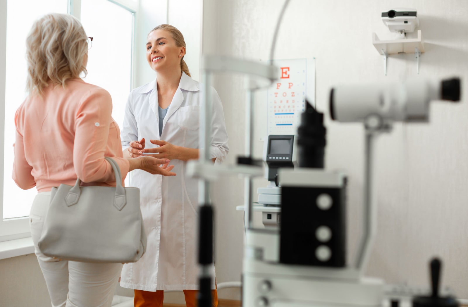 A female patient discusses dry eye treatment options with her optometrist