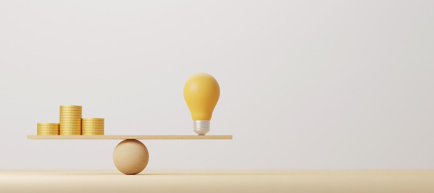 A light bulb on a balance

Description automatically generated