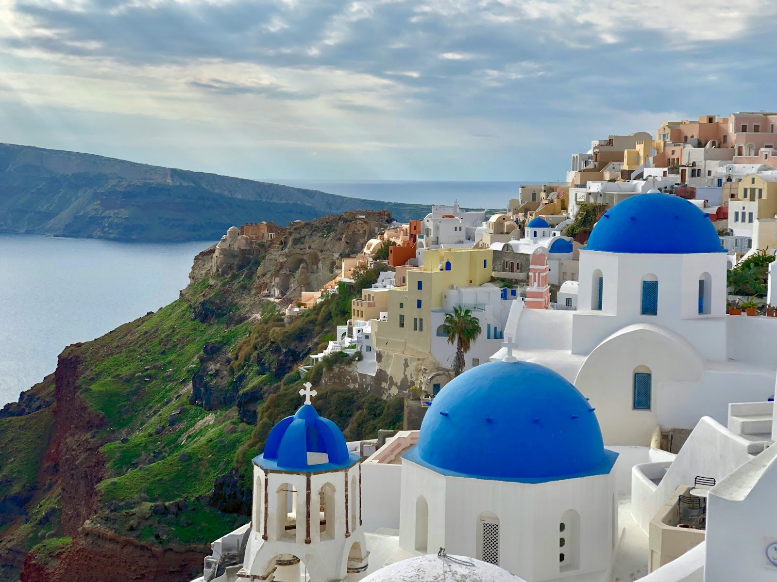  A breathtaking panoramic view of Santorini's whitewashed buildings cascading down the cliffs.