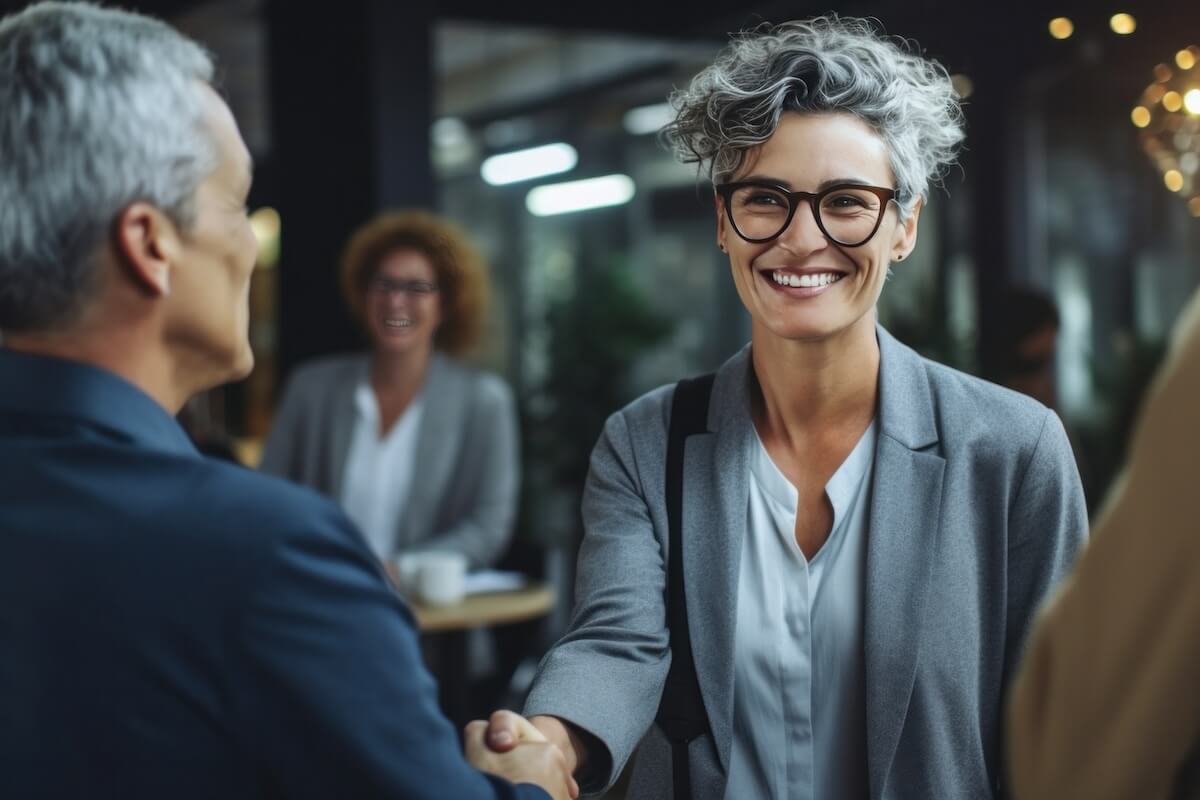 Entrepreneur shaking hands with her colleague