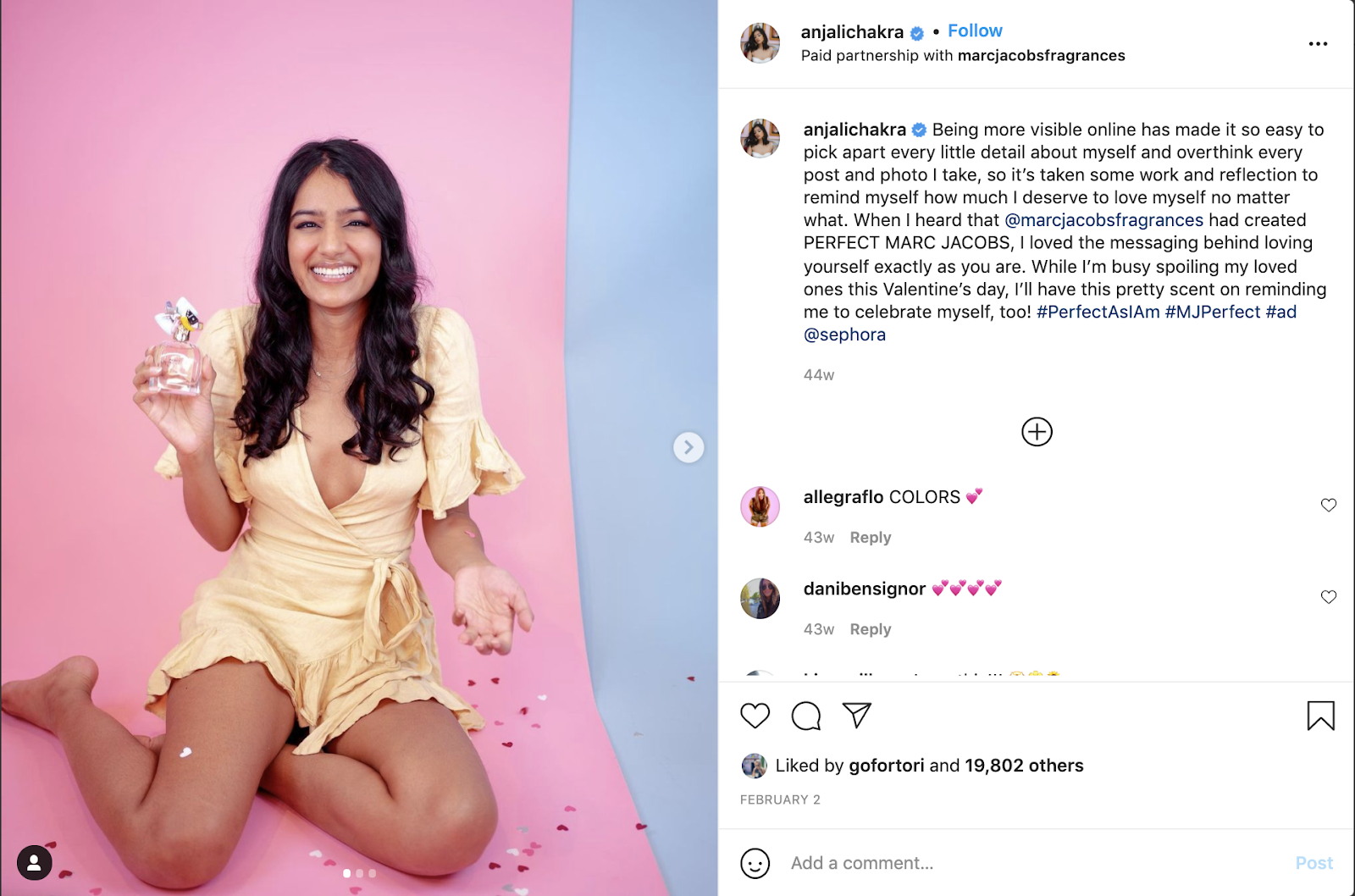 Screenshot of Instagram post in which influencer is posing with MARC JACOBS perfume called PERFECT in front of a pink background with heart-shaped confetti. The Valentine's Day influencer marketing post includes a caption about the brand