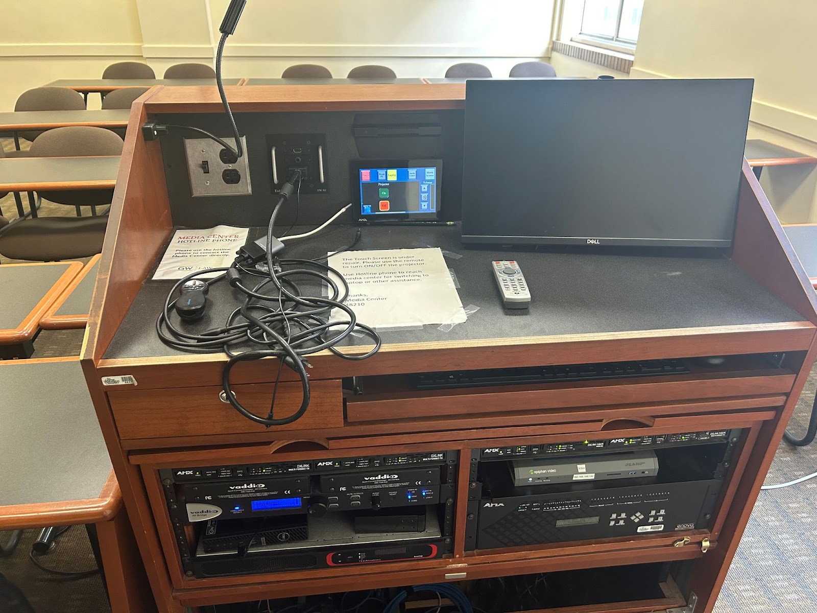 View of the lectern: Computer, monitor, lectern mic, touch control panel.