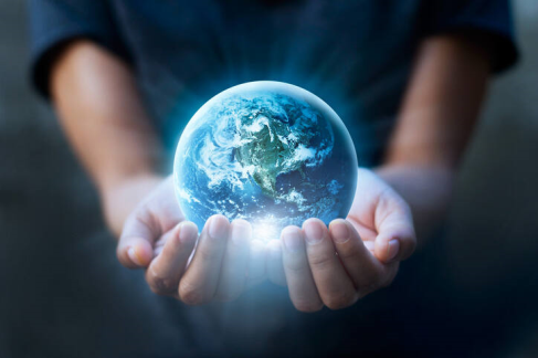 A person holding a planet earth

Description automatically generated