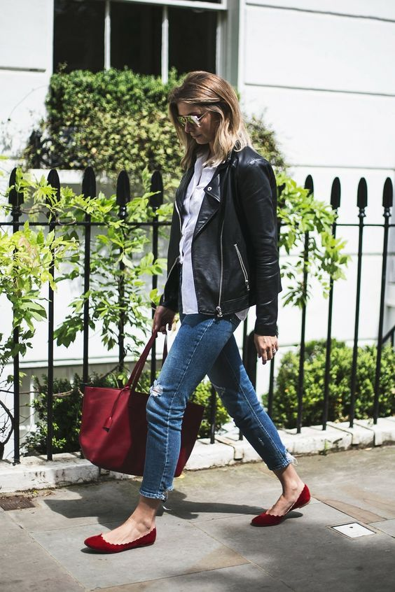 A leather jacket with red ballet flats creates a stylish look