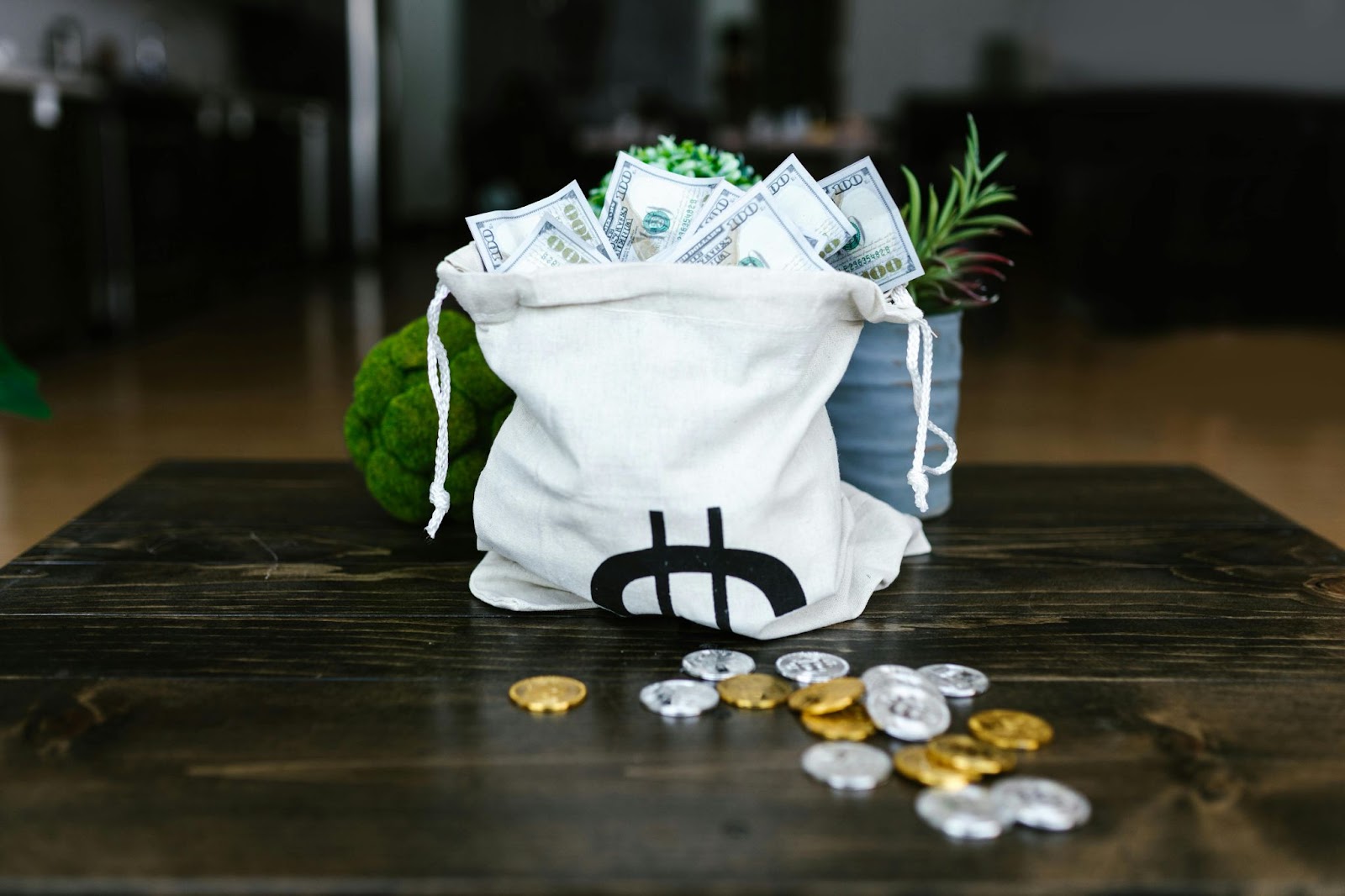 A bag full of money and currencies on the table