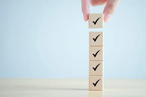 Blocks With Checkmarks On Them Stacked On Top of One Another