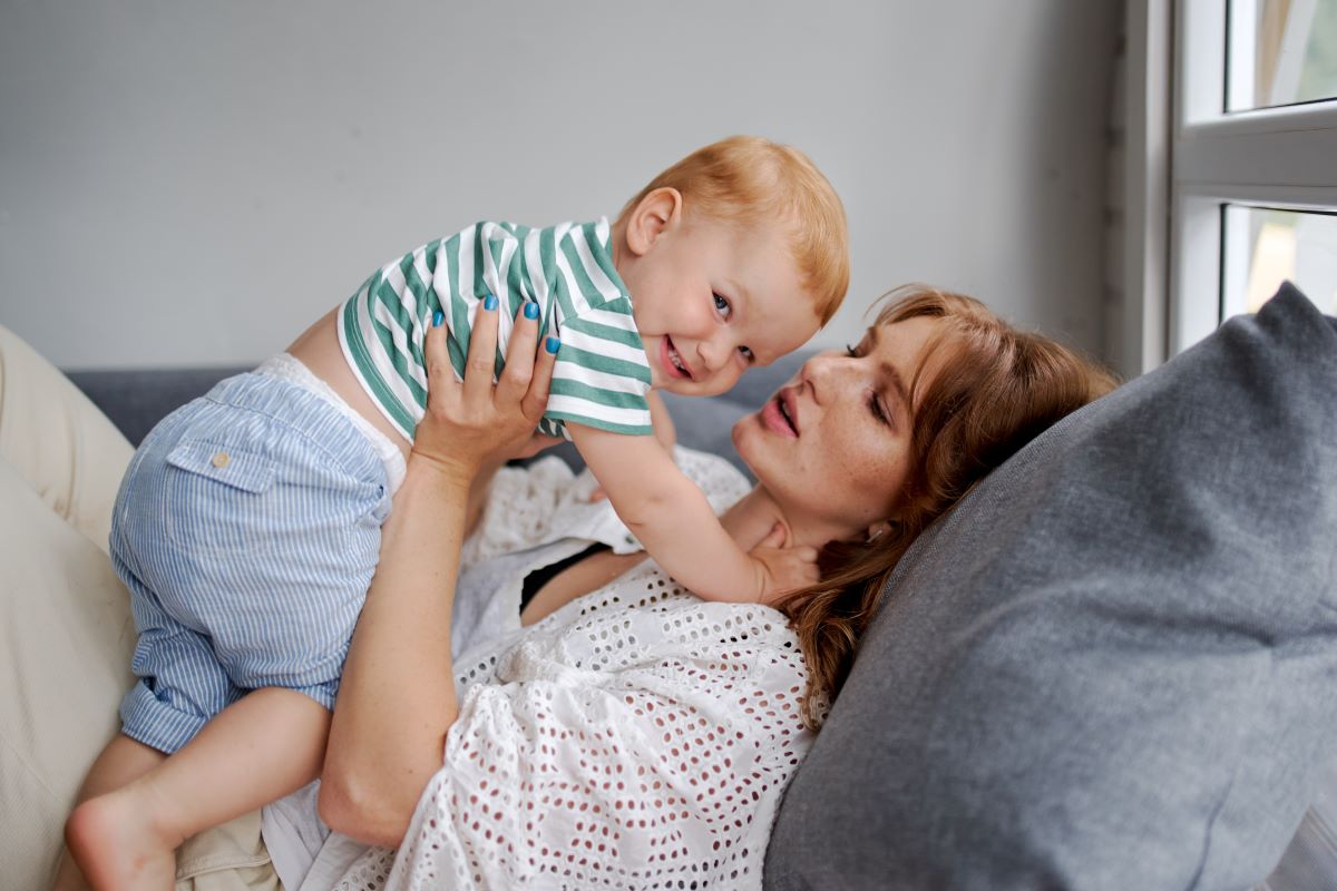 mom holding smiling baby