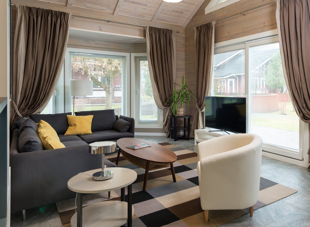 interior of stylish living room with big windows