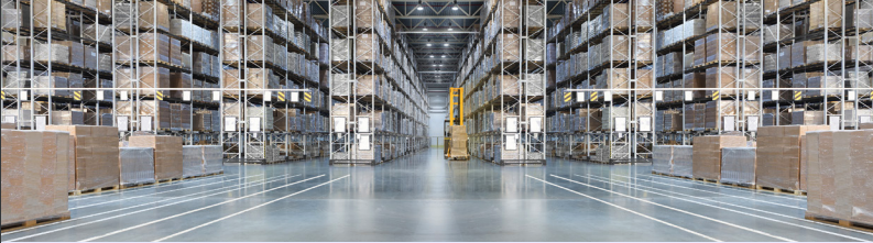 View from inside a large warehouse showing many full racks with pallets