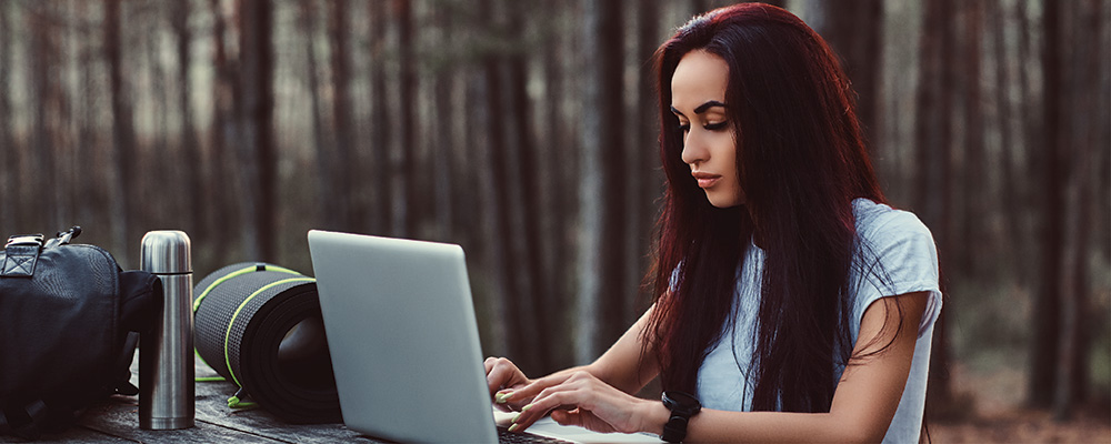 A digital nomad looking something up on their laptop